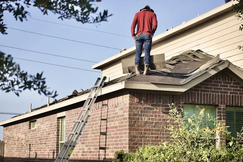 Professional roofer working on a residential roof in Ryle